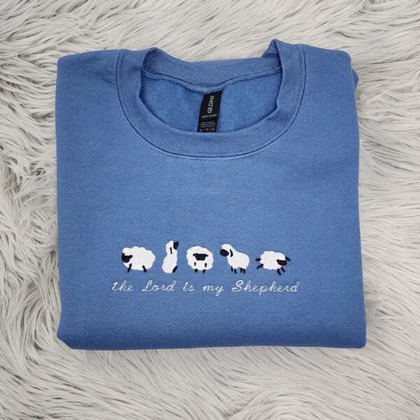 Psalm 23 sweatshirt in blue with five embroidered sheep above the Lord is my Shepherd in white script