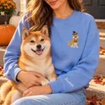 Shiba Inu mom wearing the Heather Deep Royal Halloween sweatshirt with her Shiba Inu on a fall porch