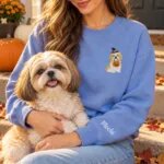 Shih Tzu mom wearing the Heather Deep Royal Halloween sweatshirt with her Shih Tzu on a fall porch