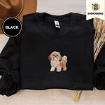 Black crewneck sweatshirt with a brown felt hat and dried bunny tail grass, embroidered with a gold and white Shih Tzu puppy with a long silky coat and a plumed tail