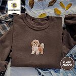 Dark Chocolate crewneck sweatshirt on a plaid flannel shirt with yellow autumn leaves and denim shorts, embroidered with a gold and white Shih Tzu puppy with a long silky coat and a plumed tail