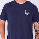 Man in a True Navy T-shirt embroidered with a white goose and the words silly dada in white thread