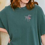 Woman in a Blue Spruce T-shirt with a silver lab silhouette and American flag stitched on the left chest