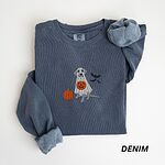 Denim crewneck sweatshirt laid flat, embroidered with a silver-gray Labrador under a white ghost sheet holding a jack-o'-lantern bucket