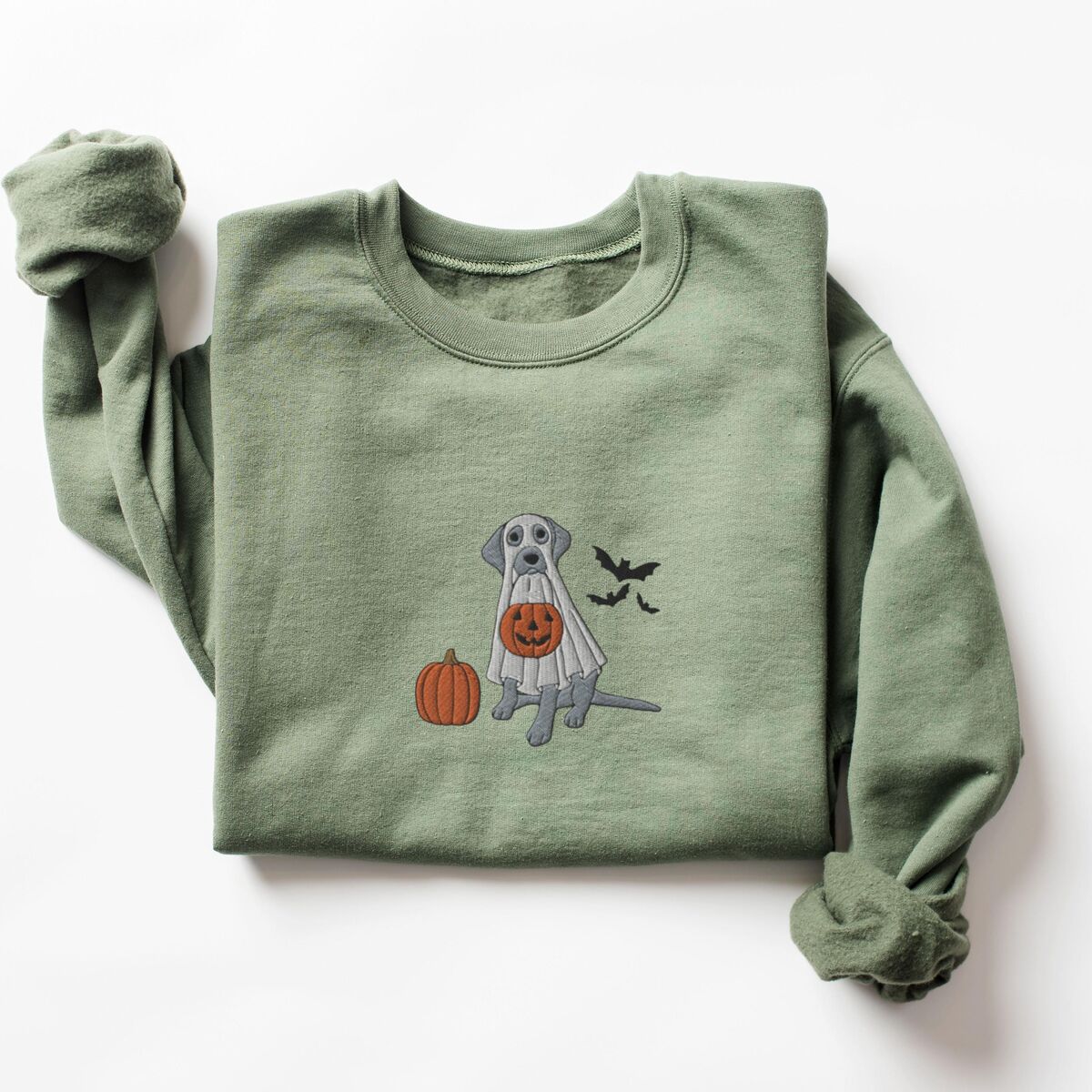 Silver Lab Ghost Sweatshirt - Military Green Military Green crewneck sweatshirt laid flat with rolled cuffs, embroidered with a silver Labrador in a white ghost sheet holding a jack-o'-lantern bucket beside a pumpkin and three bats