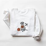 White crewneck sweatshirt laid flat, embroidered with a silver Labrador in a ghost costume, an orange pumpkin and three black bats