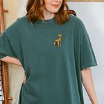 Woman in a Blue Spruce T-shirt embroidered with a small sitting golden retriever on the left chest