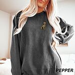 Woman in a Pepper crewneck sweatshirt embroidered with a small sitting golden retriever on the left chest