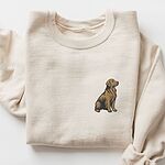 Sand crewneck sweatshirt laid flat with a rolled cuff, embroidered with a small sitting golden retriever on the left chest