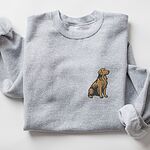 Sport Grey crewneck sweatshirt laid flat with a rolled cuff, embroidered with a small sitting golden retriever on the left chest