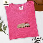 Crunchberry Comfort Colors T-shirt embroidered with a golden retriever puppy napping with its head on its paws in a red Santa hat