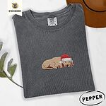 Pepper Comfort Colors T-shirt embroidered with a golden retriever puppy napping with its head on its paws in a red Santa hat