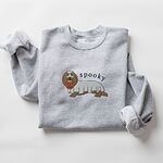 Sport Grey crewneck sweatshirt laid flat on white, embroidered in the center with a long-haired dachshund in a ghost sheet carrying a jack-o'-lantern bucket under the word spooky