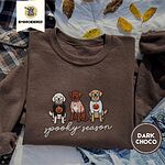 Dark Chocolate crewneck sweatshirt on a plaid flannel shirt with yellow autumn leaves and denim shorts, embroidered with a doodle, a chocolate lab and a golden retriever in Halloween sweaters above spooky season in script