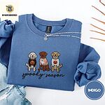 Indigo Blue crewneck sweatshirt folded with light jeans and dried twigs, embroidered with a doodle, a chocolate lab and a golden retriever in Halloween sweaters above spooky season in script