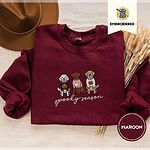 Maroon crewneck sweatshirt with a brown felt hat and dried bunny tail grass, embroidered with a doodle, a chocolate lab and a golden retriever in Halloween sweaters above spooky season in script