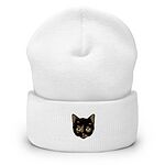 White cuffed knit beanie with a tortoiseshell cat face, black with caramel patches, embroidered on the cuff