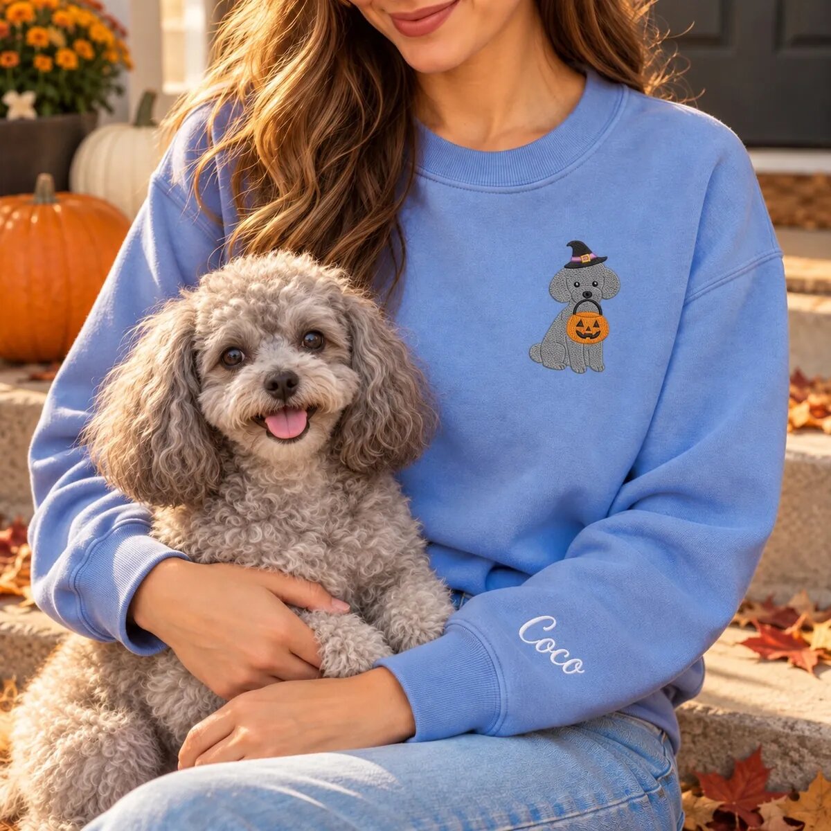 Toy Poodle Mom Halloween Sweatshirt Worn Toy Poodle mom wearing the Heather Deep Royal Halloween sweatshirt with her Toy Poodle on a fall porch