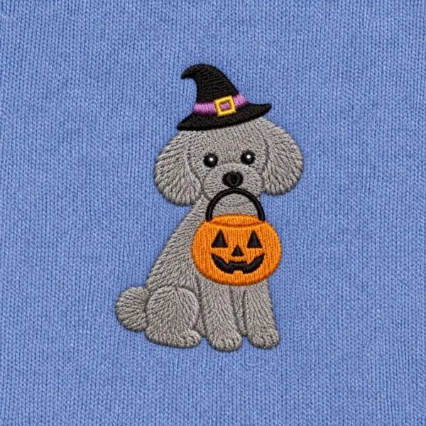 Close-up of the embroidered Toy Poodle in a witch hat with a jack-o'-lantern candy bucket