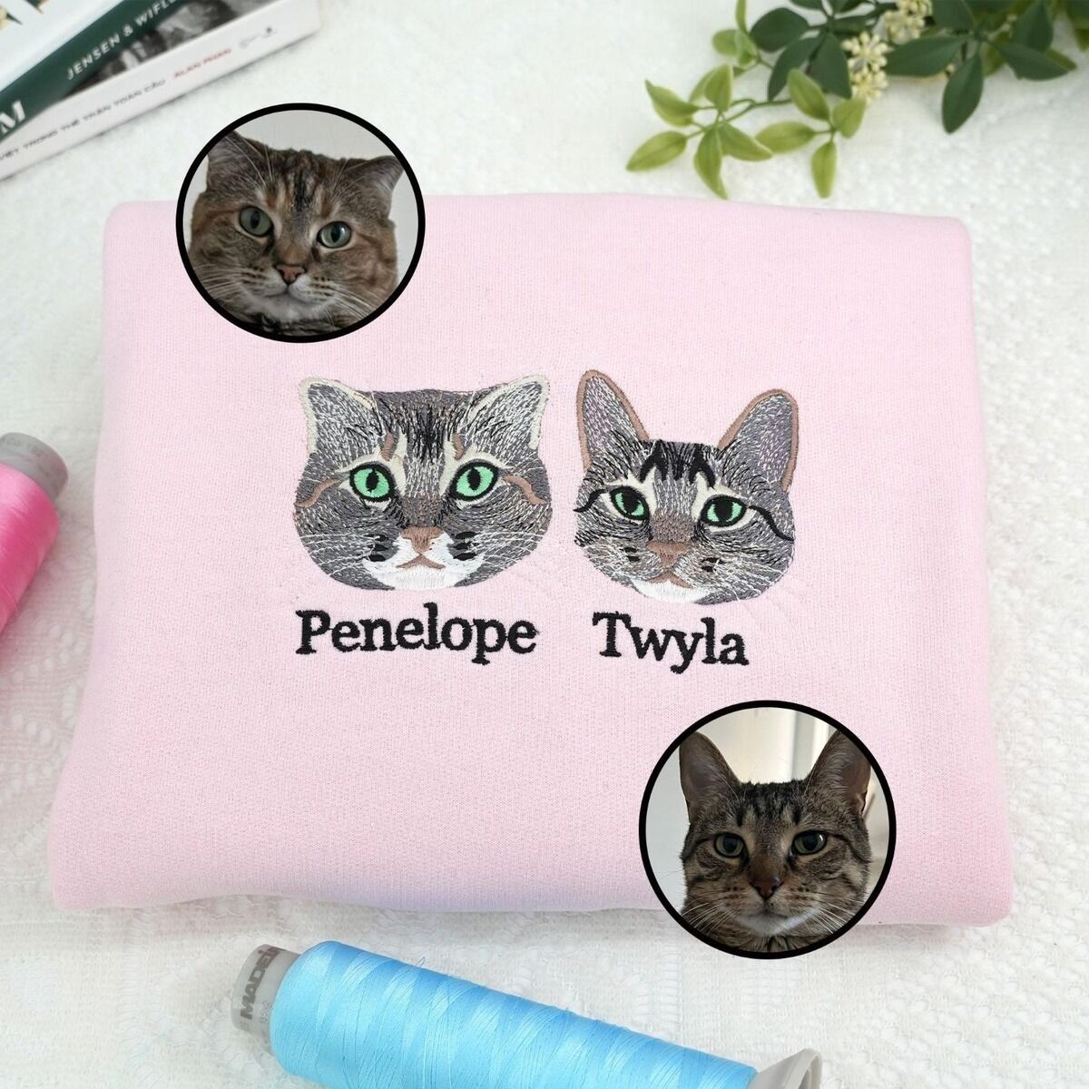 Two Cat Face Sweatshirt with Names Light pink embroidered cat sweatshirt with two tabby cat faces named Penelope and Twyla, shown with the two original photos