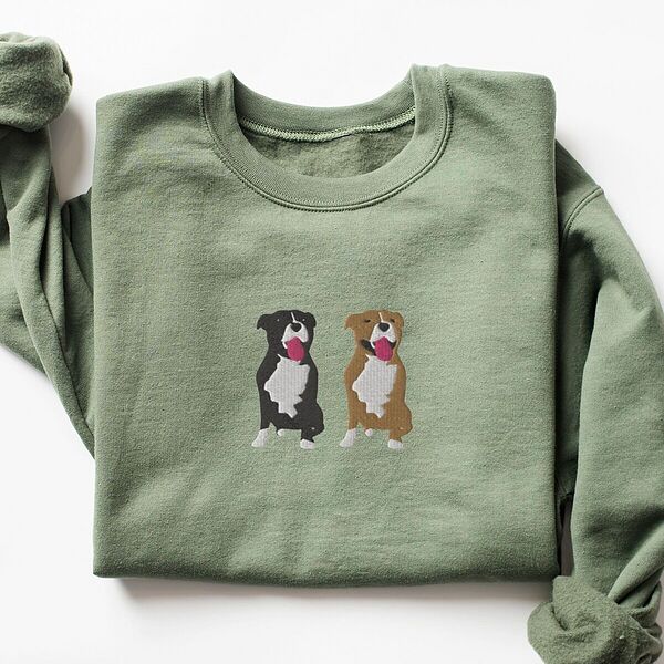 Military Green crewneck sweatshirt laid flat, embroidered with a black and white tuxedo pit bull and a fawn pit bull sitting side by side with their tongues out, centered on the chest