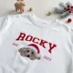 Varsity dog name sweatshirt with an embroidered Santa hat portrait and EST year on white fleece