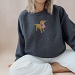 Woman sitting in a Dark Heather crewneck sweatshirt with a golden yellow lab carrying an American flag centered on the chest