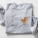 Light grey crewneck sweatshirt laid flat with a golden lab silhouette holding a USA flag on the left chest