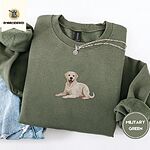 Military Green crewneck sweatshirt folded with light jeans and a silver chain necklace, embroidered with a smiling yellow Labrador lying down with its front paws stretched out