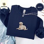Navy crewneck sweatshirt folded with ripped jeans and a silver chain necklace, embroidered with a smiling yellow Labrador lying down with its front paws stretched out