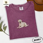 Berry Comfort Colors T-shirt embroidered with a smiling yellow Labrador lying down with its front paws stretched out