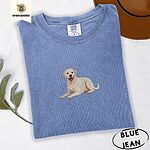 Blue Jean Comfort Colors T-shirt embroidered with a smiling yellow Labrador lying down with its front paws stretched out