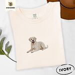 Ivory Comfort Colors T-shirt embroidered with a smiling yellow Labrador lying down with its front paws stretched out