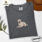Pepper Comfort Colors T-shirt embroidered with a smiling yellow Labrador lying down with its front paws stretched out
