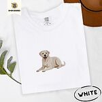 White Comfort Colors T-shirt embroidered with a smiling yellow Labrador lying down with its front paws stretched out