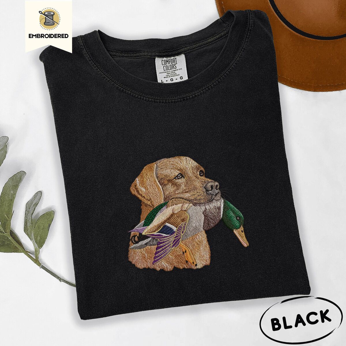Yellow Lab Shirt – Black Black Comfort Colors T-shirt embroidered with a yellow Labrador head carrying a mallard drake in its mouth