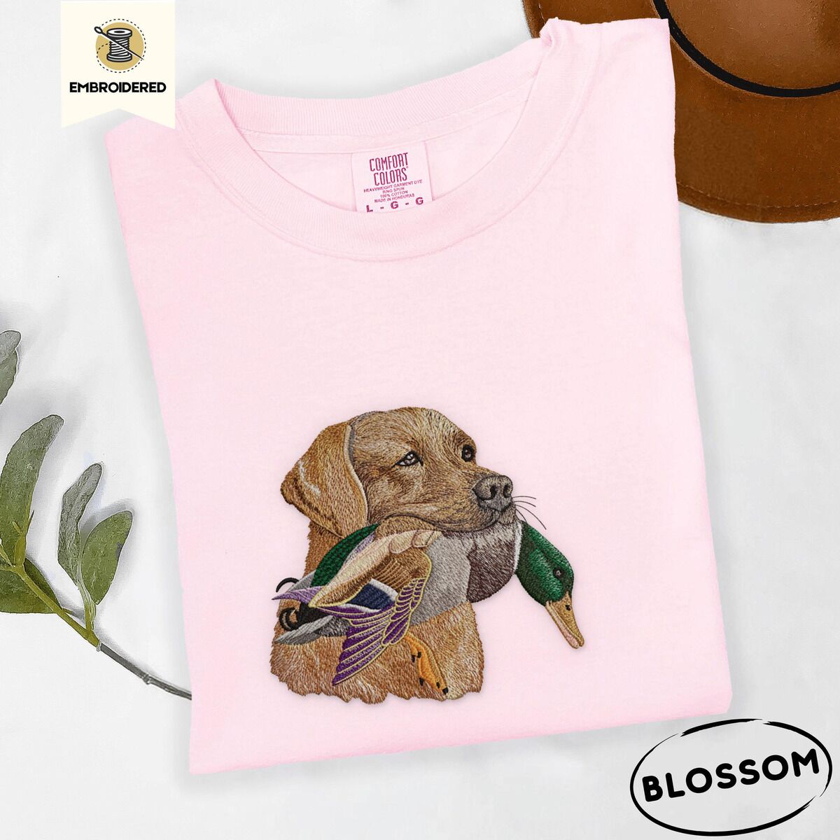 Yellow Lab Shirt – Blossom Blossom Comfort Colors T-shirt embroidered with a yellow Labrador head carrying a mallard drake in its mouth