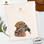 Ivory Comfort Colors T-shirt embroidered with a yellow Labrador head carrying a mallard drake in its mouth