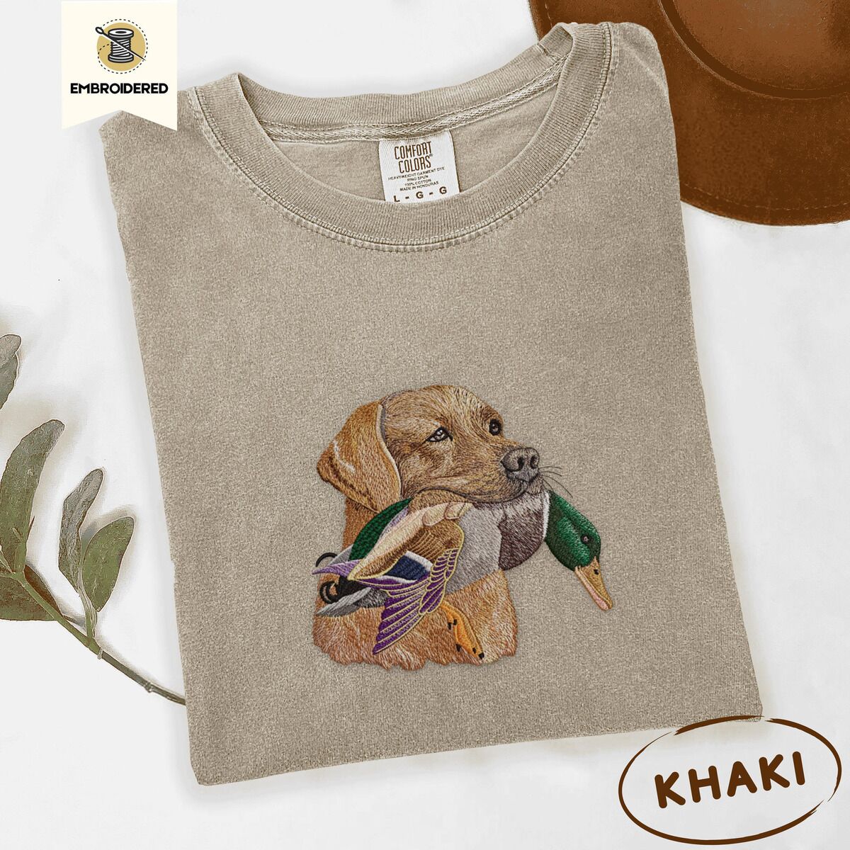 Yellow Lab Shirt – Khaki Khaki Comfort Colors T-shirt embroidered with a yellow Labrador head carrying a mallard drake in its mouth