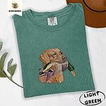 Light Green Comfort Colors T-shirt embroidered with a yellow Labrador head carrying a mallard drake in its mouth