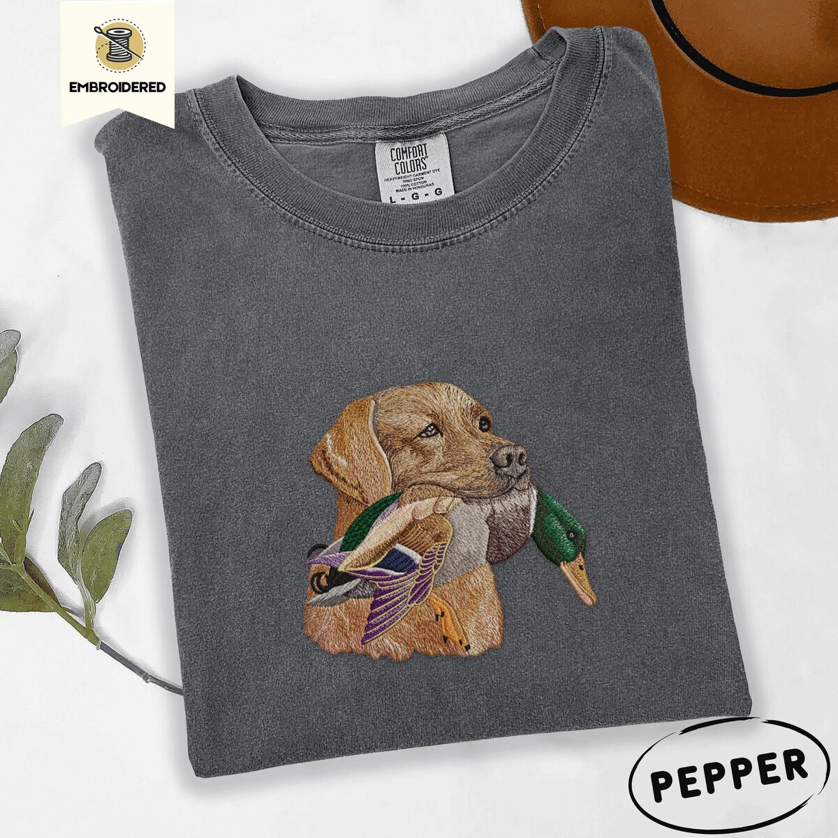 Yellow Lab Shirt – Pepper Pepper Comfort Colors T-shirt embroidered with a yellow Labrador head carrying a mallard drake in its mouth