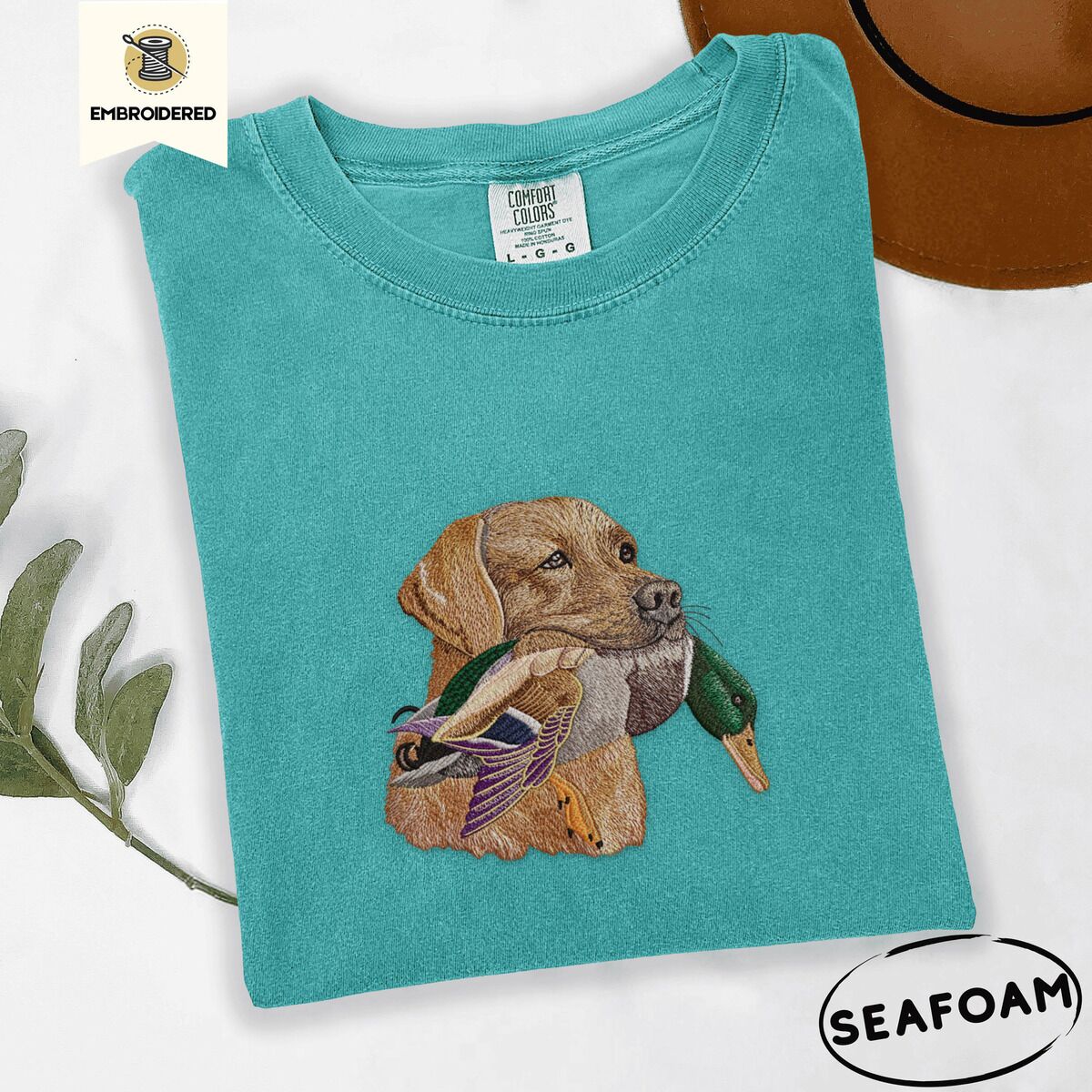 Yellow Lab Shirt – Seafoam Seafoam Comfort Colors T-shirt embroidered with a yellow Labrador head carrying a mallard drake in its mouth