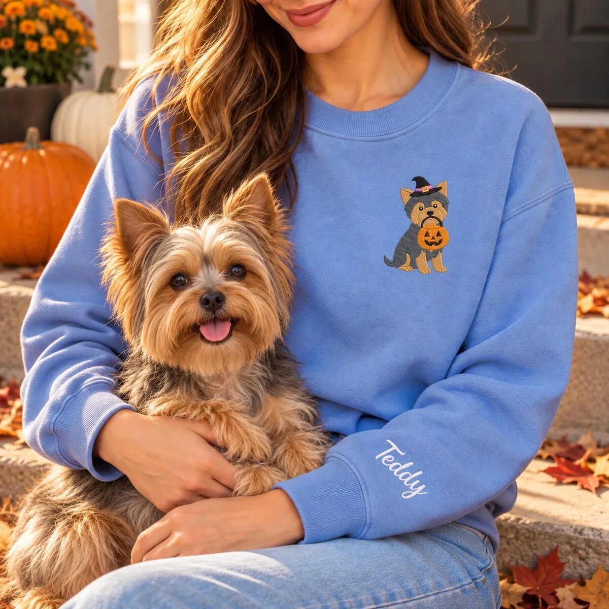 Yorkie Mom Halloween Sweatshirt Worn Yorkie mom wearing the Heather Deep Royal Halloween sweatshirt with her Yorkshire Terrier on a fall porch